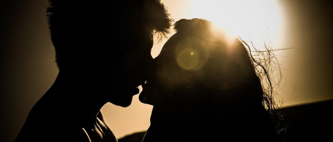 man and woman kissing