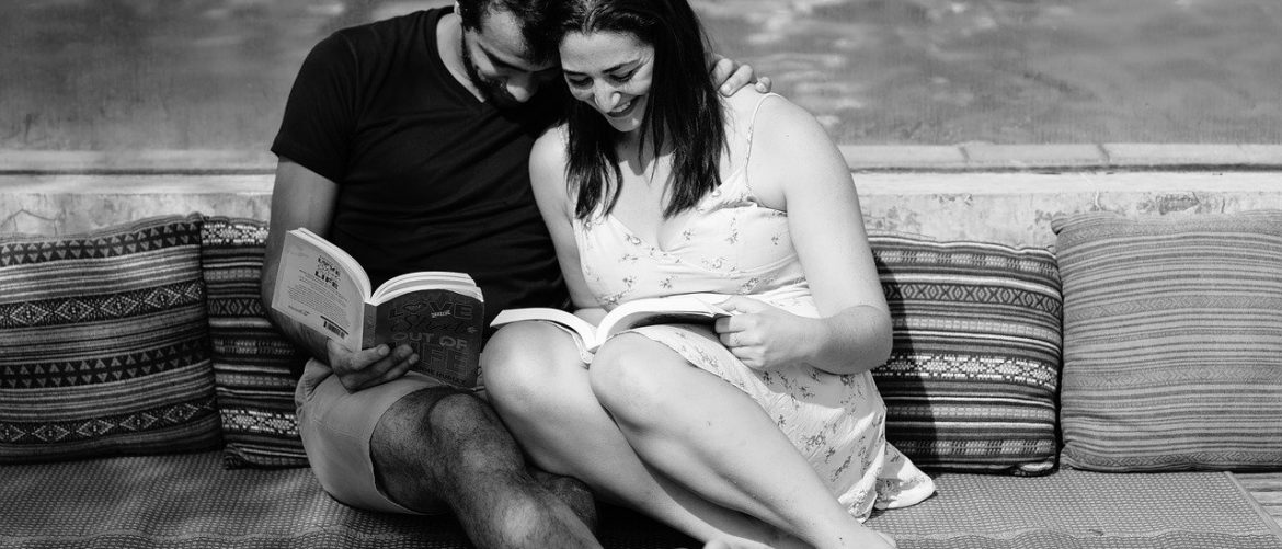 Couple sitting down reading